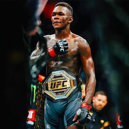 Adesanya with the undisputed belt over his shoulder